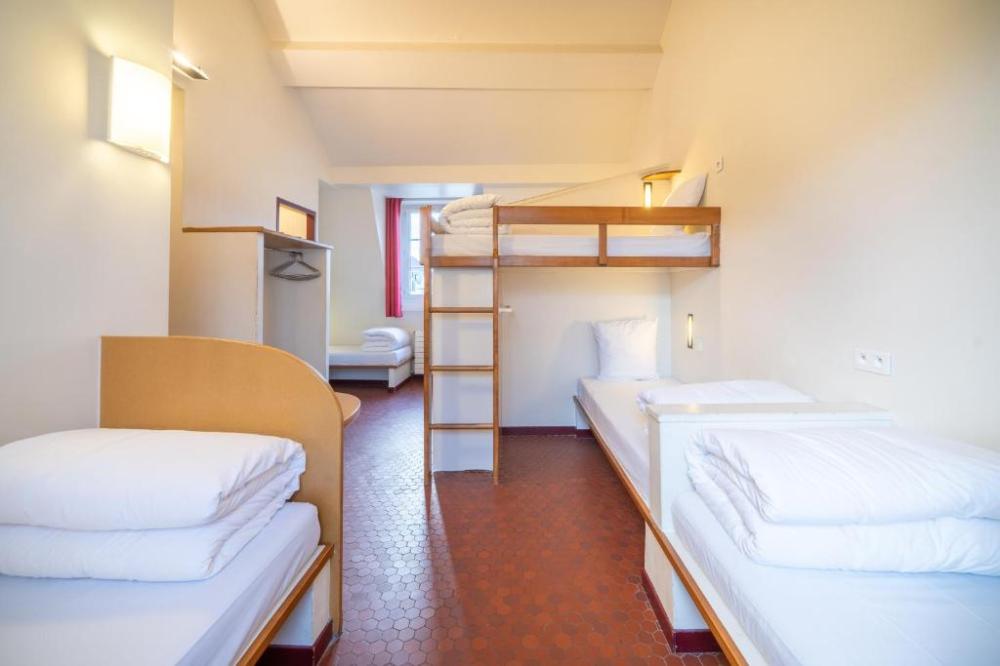 Letto in dormitorio maschile con 10 letti.